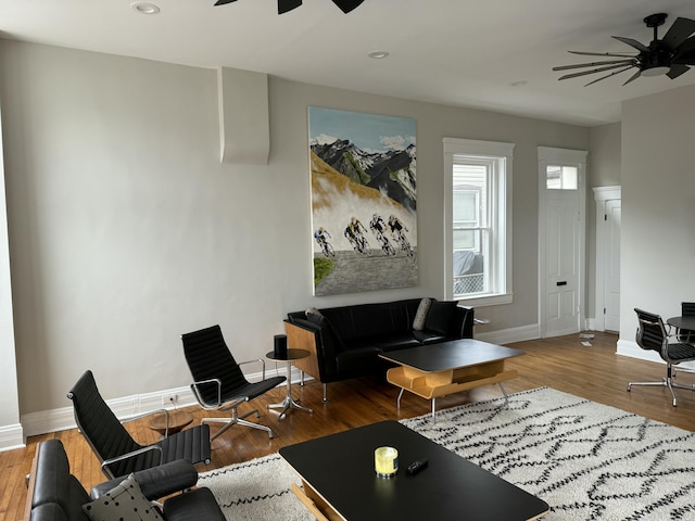 living area with recessed lighting, ceiling fan, baseboards, and wood finished floors