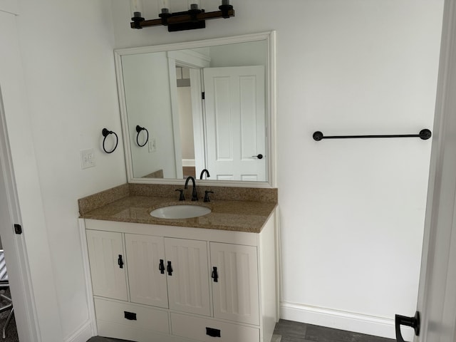 bathroom with baseboards and vanity