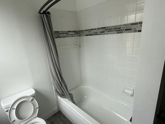 full bathroom with toilet, shower / tub combo, baseboards, and wood finished floors