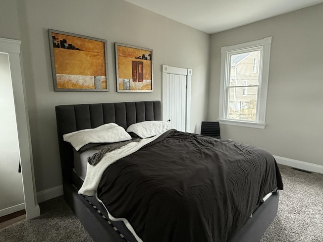 bedroom featuring carpet flooring, visible vents, and baseboards