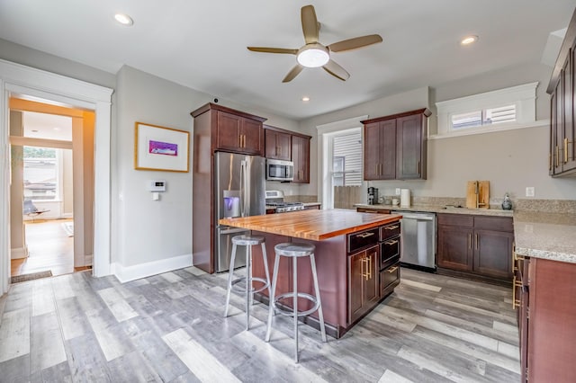 639 Watkins St, Covington, KY 41011 - kitchen featuring stainless steel appliances, wood counters, ceiling fan, light wood-style flooring, and recessed lighting