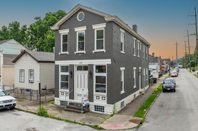 639 Watkins St, Covington, KY 41011 - view of front facade featuring entry steps, a chimney, and brick siding