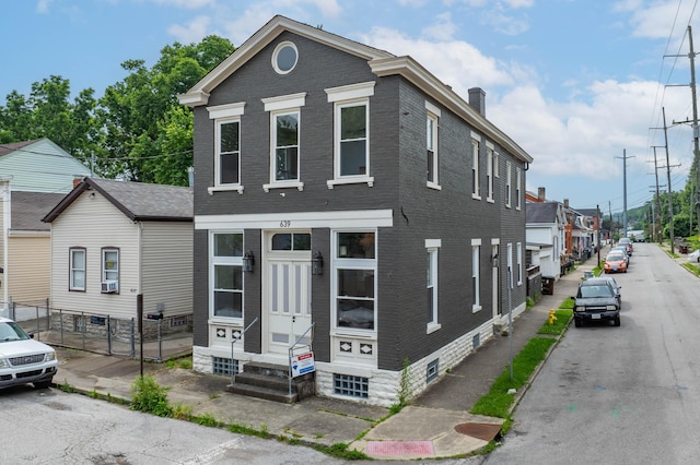 639 Watkins St, Covington, KY 41011 - view of front facade featuring brick siding, a chimney, and entry steps