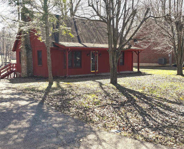 view of front of house featuring central AC and a shingled roof