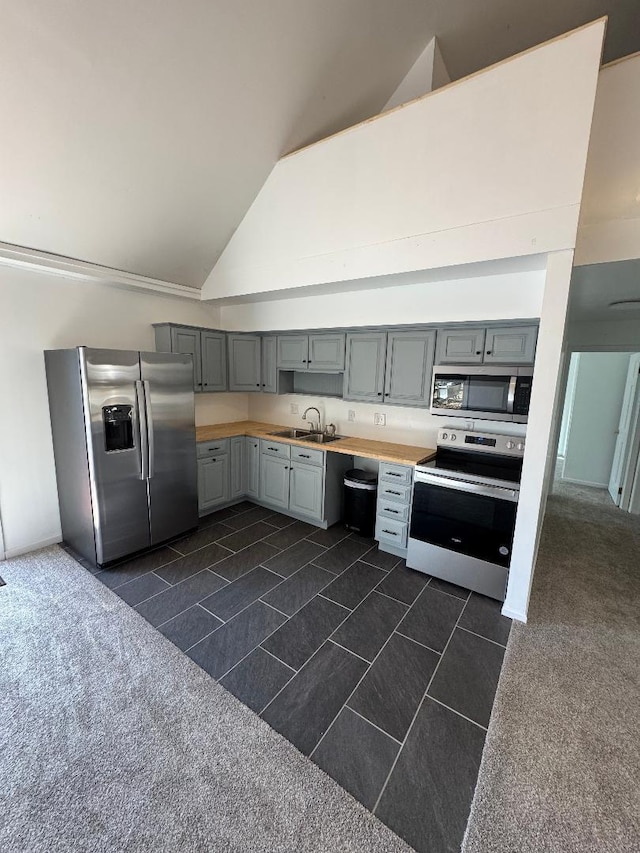 kitchen with gray cabinets, appliances with stainless steel finishes, light countertops, and a sink