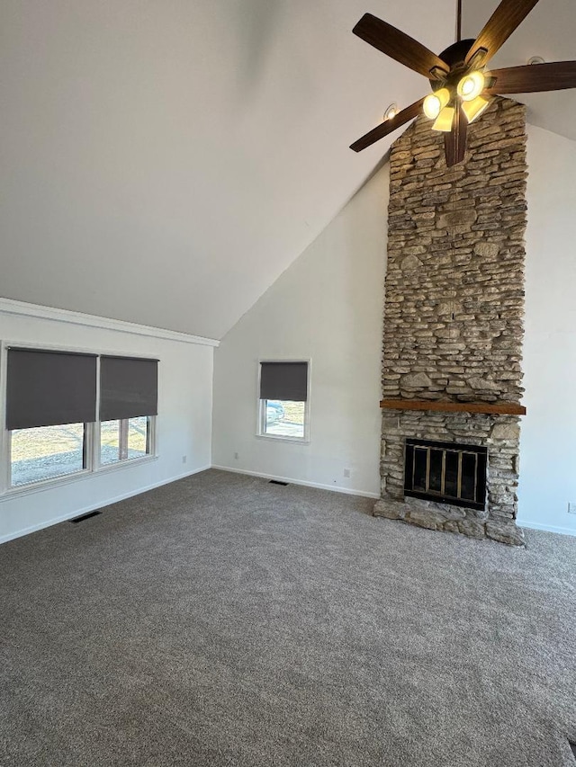 unfurnished living room with visible vents, carpet flooring, a fireplace, and a healthy amount of sunlight