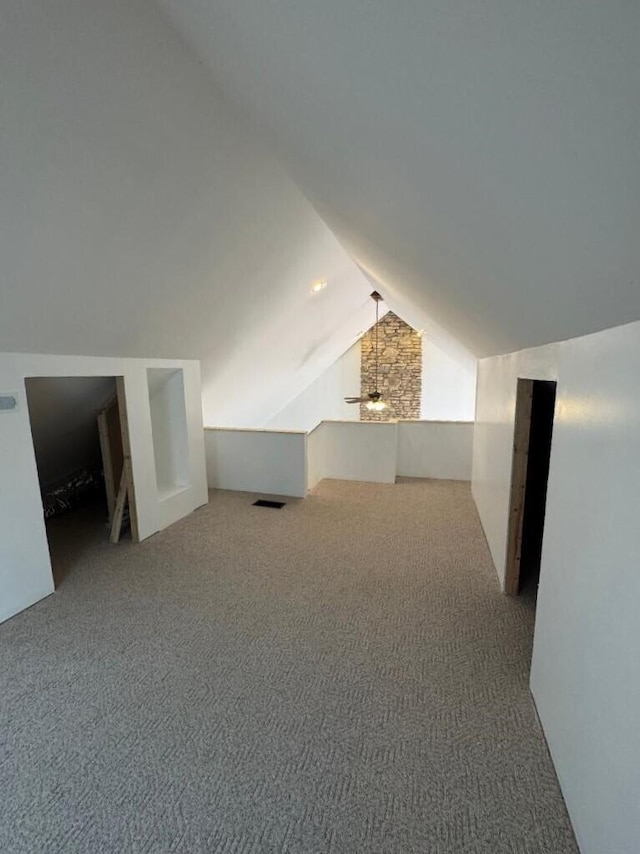 bonus room featuring vaulted ceiling, a ceiling fan, and carpet floors