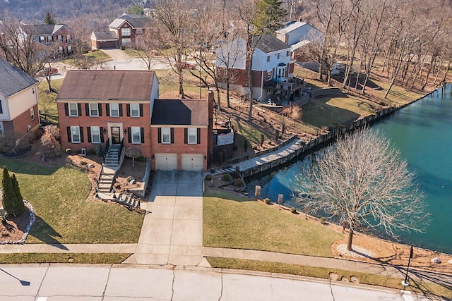 bird's eye view with a residential view and a water view