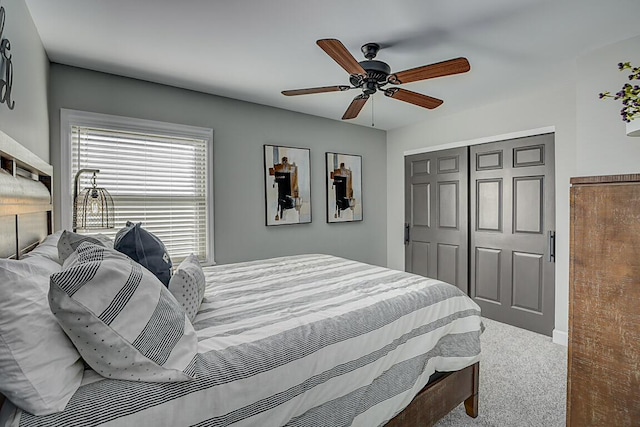 carpeted bedroom with a closet and ceiling fan