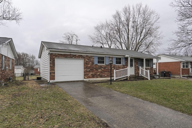 single story home featuring aphalt driveway, brick siding, an attached garage, fence, and a front lawn