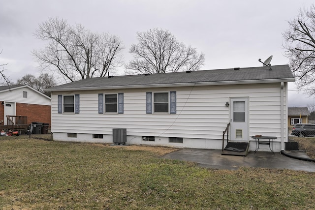 back of house featuring cooling unit, a patio area, and a yard