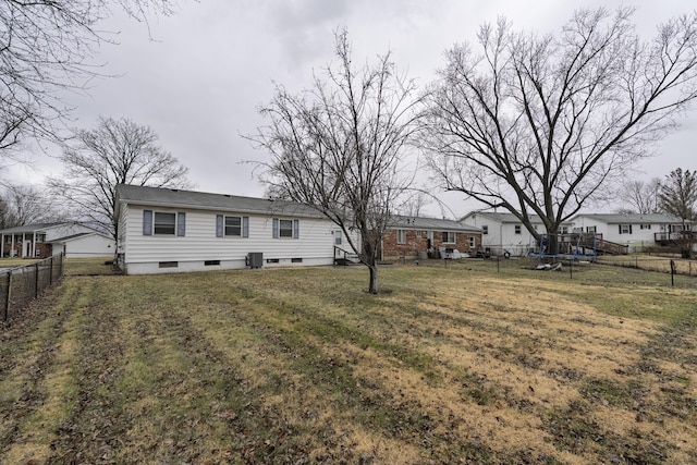 rear view of property with a lawn and a fenced backyard