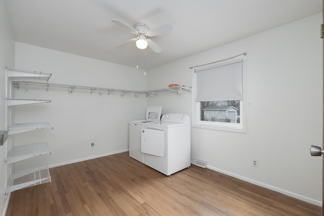 laundry room featuring laundry area, light wood-style flooring, baseboards, and washer and dryer