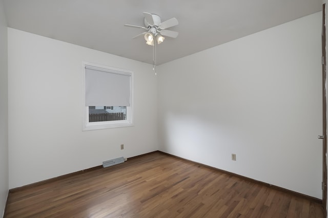 unfurnished room featuring visible vents, ceiling fan, baseboards, and wood finished floors