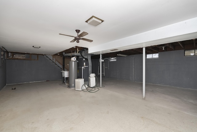 below grade area featuring water heater and a ceiling fan