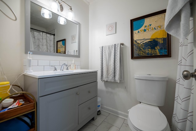 full bathroom with toilet, vanity, and baseboards