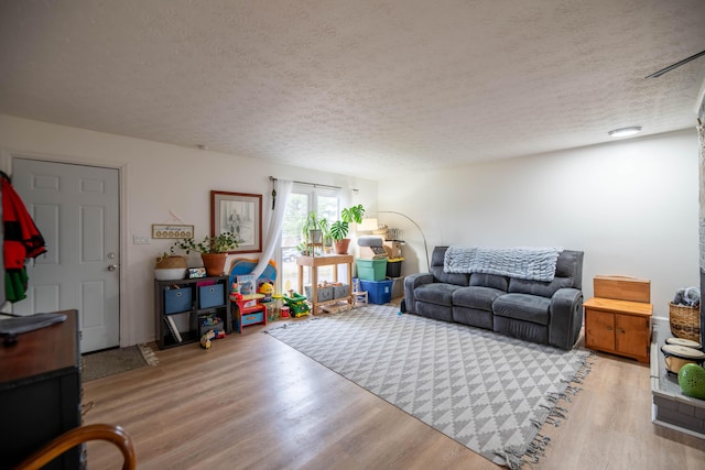 living area featuring a textured ceiling and wood finished floors