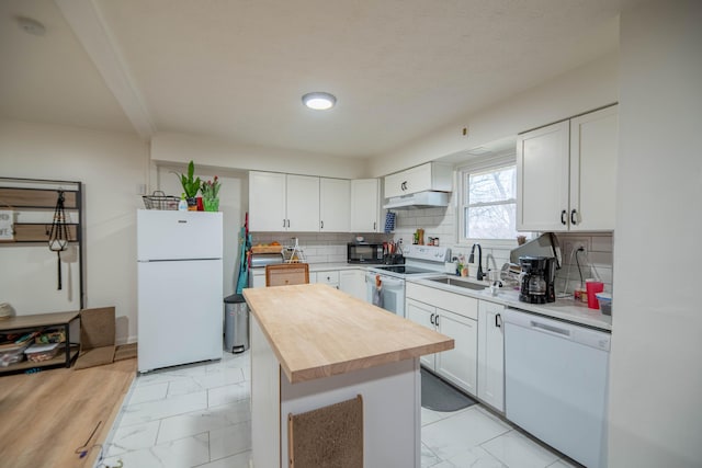 kitchen featuring a sink, white appliances, marble finish floor, and under cabinet range hood