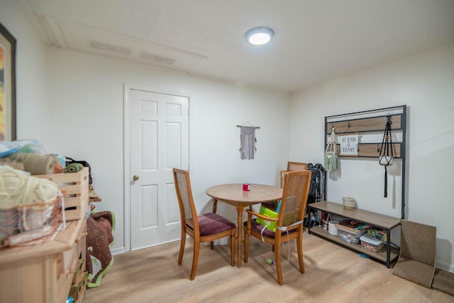 dining space with light wood-type flooring and visible vents