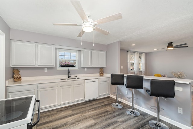 kitchen featuring a sink, range with electric stovetop, ceiling fan, and white dishwasher