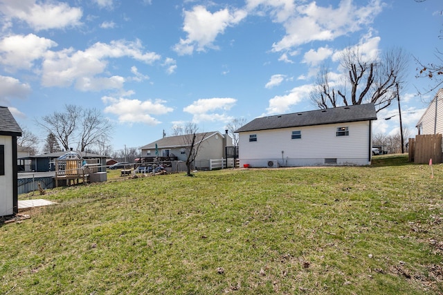 view of yard featuring fence and a wooden deck