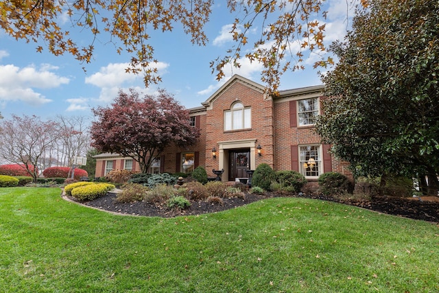 view of front of home with brick siding and a front lawn