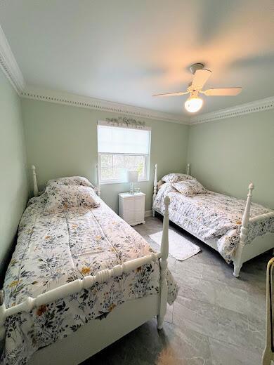 bedroom featuring ceiling fan and crown molding