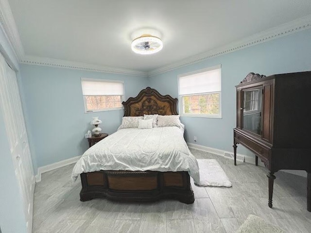 bedroom featuring multiple windows, baseboards, and crown molding