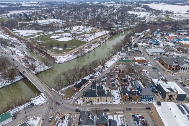 snowy aerial view with a water view