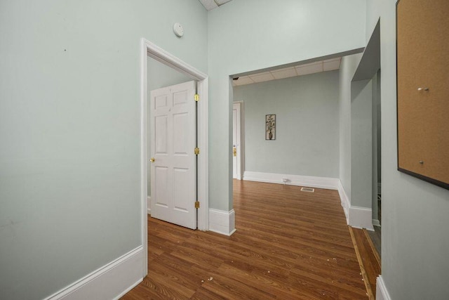 hall featuring wood finished floors and baseboards