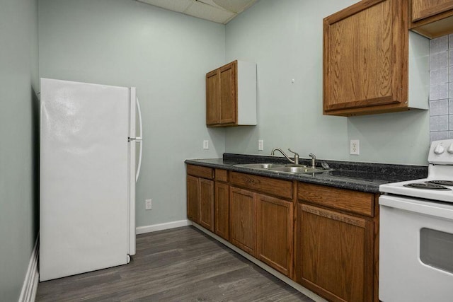 kitchen with white appliances, brown cabinets, and a sink