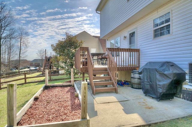 view of patio featuring grilling area, a wooden deck, stairs, and fence