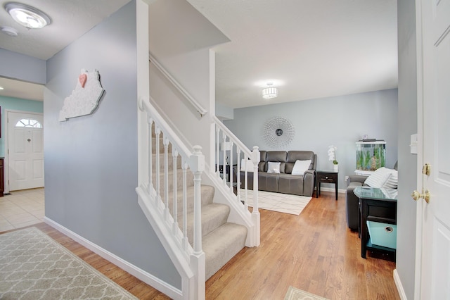 stairway featuring baseboards and wood finished floors