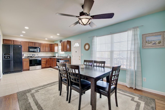 dining room featuring light tile patterned floors, recessed lighting, and baseboards