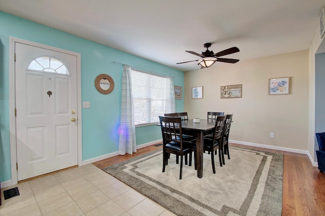 dining space with wood finished floors, visible vents, baseboards, and ceiling fan