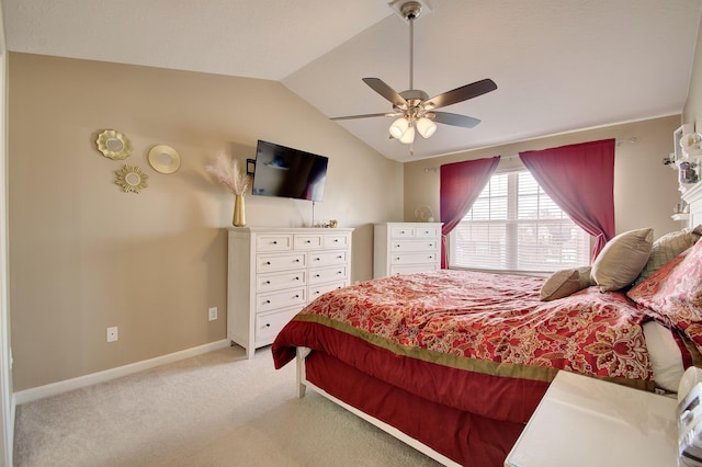 bedroom with light colored carpet, a ceiling fan, baseboards, and vaulted ceiling