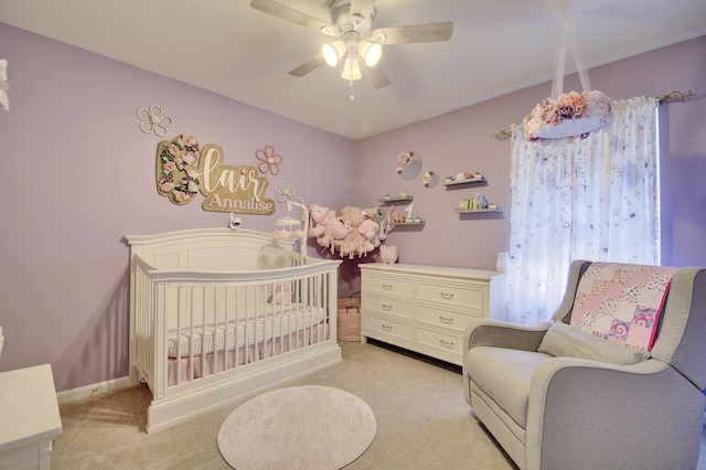 bedroom featuring baseboards, light colored carpet, and a ceiling fan