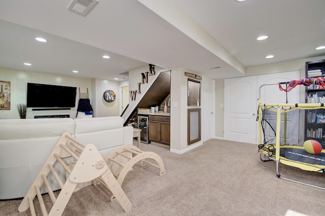 interior space featuring beverage cooler, visible vents, recessed lighting, and stairway