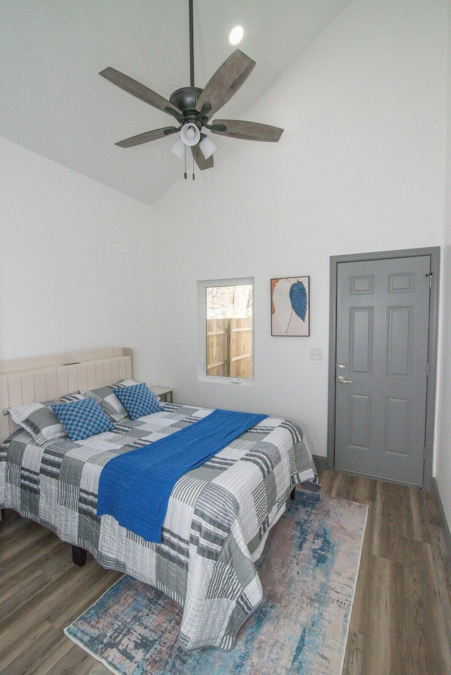 bedroom featuring ceiling fan, high vaulted ceiling, and wood finished floors