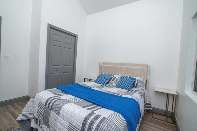 bedroom with wood finished floors and baseboards