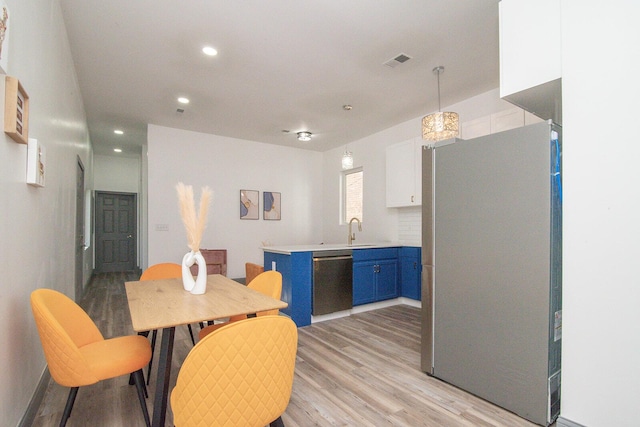 dining room featuring light wood-type flooring, visible vents, and recessed lighting