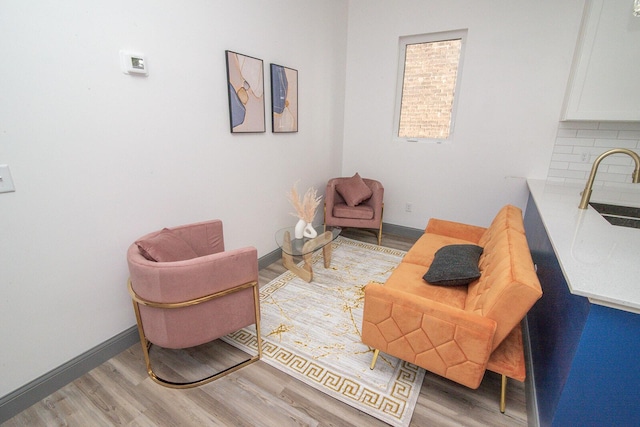 sitting room featuring light wood-style floors and baseboards