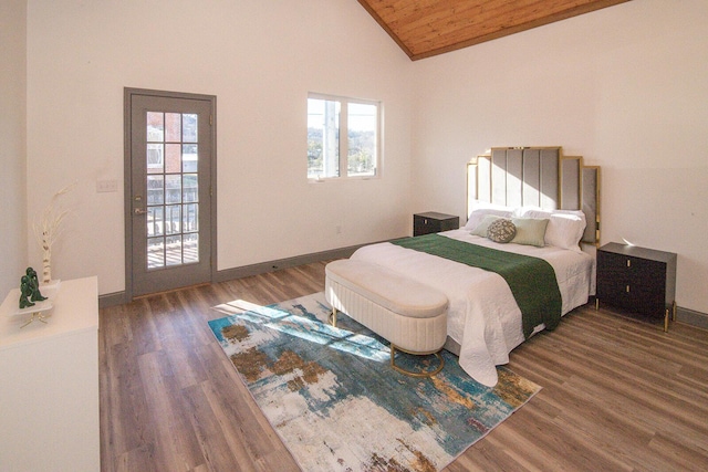 bedroom with wooden ceiling, vaulted ceiling, baseboards, and wood finished floors