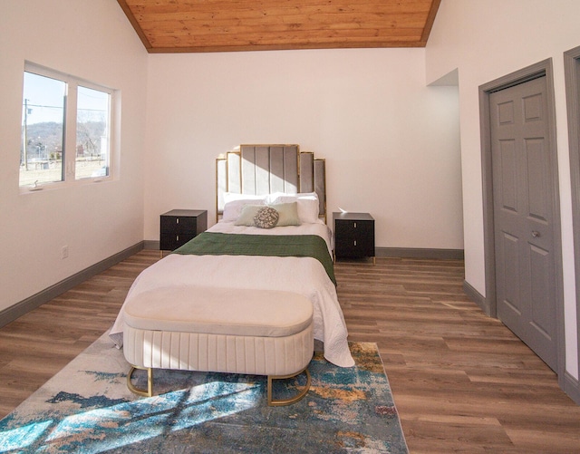 bedroom with wooden ceiling, vaulted ceiling, and wood finished floors