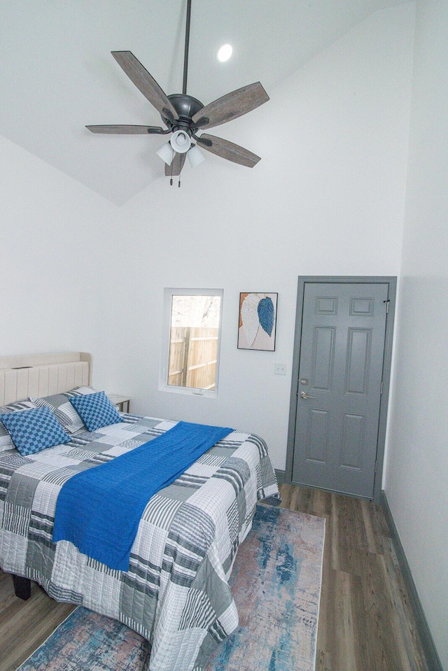 bedroom featuring baseboards, high vaulted ceiling, ceiling fan, and wood finished floors