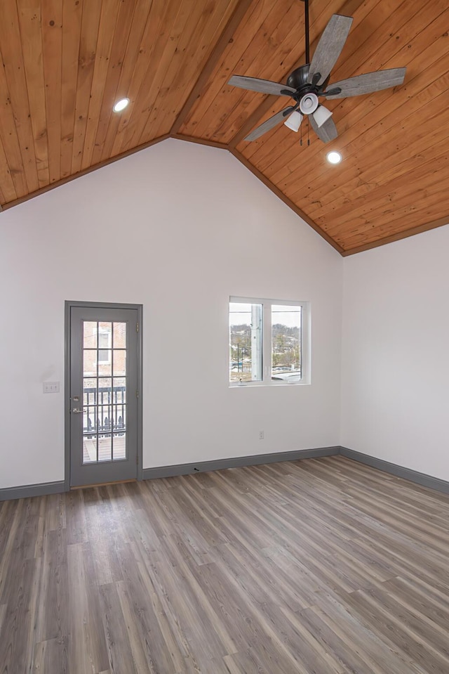 empty room with wooden ceiling, wood finished floors, and baseboards