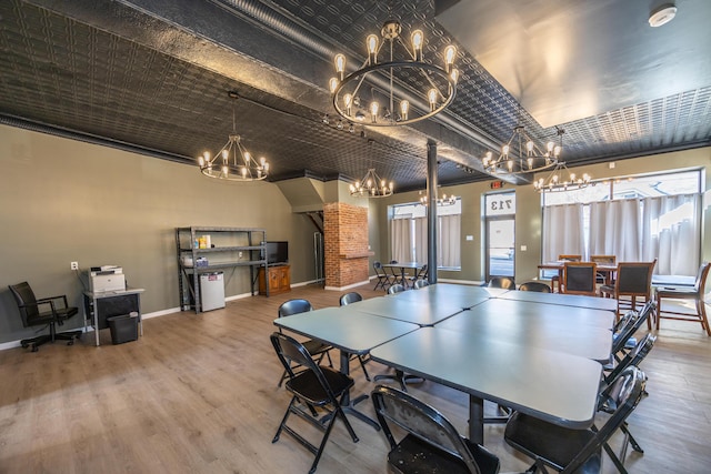 playroom with baseboards, an inviting chandelier, and wood finished floors