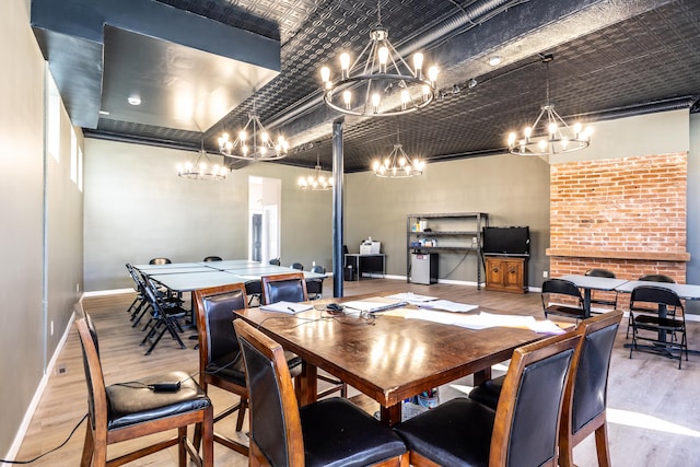 dining area featuring wood finished floors, baseboards, and an ornate ceiling