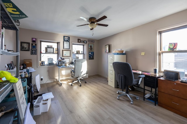 home office featuring baseboards, a ceiling fan, and wood finished floors