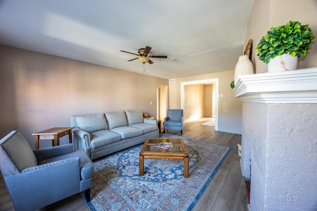 living area with ceiling fan and wood finished floors